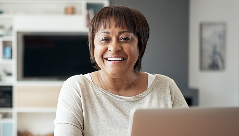 Student smiling with laptop