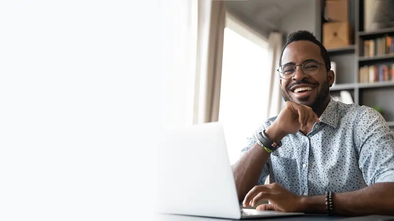Man smiling at laptop